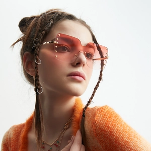 Oversized rimless square sunglasses with orange gradient lenses and gold rivets