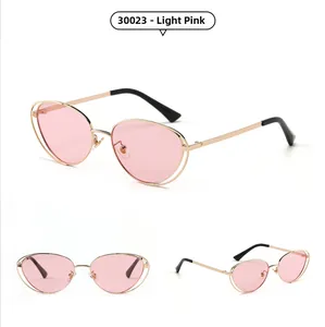 Multiple views of cat eye sunglasses featuring gold metal frames and light pink lenses
