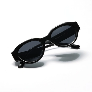 Retro oval black sunglasses with dark grey UV lenses in a sleek minimalist fashion style