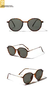 Detail of round tortoiseshell frames with dark green lenses and golden metal temples