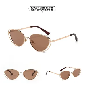 Detail view of gold frame punk cat eye sunglasses with tea lenses and double wire frame