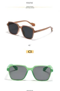 Close-up of stylish green and brown transparent square sunglasses with grey lenses