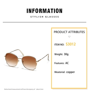 Detail of wavy-edged butterfly sunglasses with gold metal frame and gradient lenses