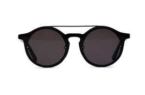 Detail of vintage round black sunglasses with dual metal bridge and dark lenses