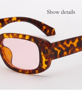 Close-up detail of vintage tortoiseshell square frame sunglasses with light pink lenses