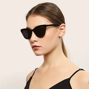 Classic black cat eye sunglasses with dark UV lenses on female model for stylish sun protection
