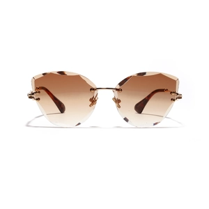 Gafas de sol cat-eye sin montura con lentes degradadas marrones y montura metálica dorada