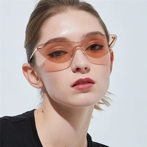 Fashionable rimless wrap-around cat eye sunglasses with amber wave lenses on a model