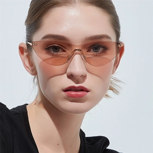 Fashionable rimless cat eye sunglasses for women with orange-brown tinted lenses and gold bridge