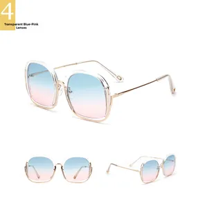Detail view of large square sunglasses with gold metal frame and blue-pink gradient lenses