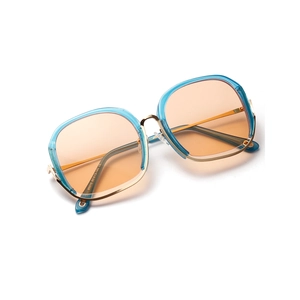 Fashionable oversized square sunglasses with blue frame and orange tinted lenses