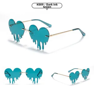 Macro view of dark green heart-shaped rimless sunglasses with fluid melting drip effect