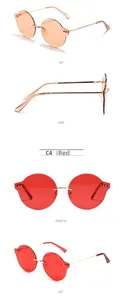 Vue détaillée de lunettes de soleil rondes sans monture avec verres orange et rouges et branches dorées