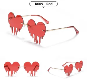 Detail view of red heart rimless sunglasses with creative melting drop lens design