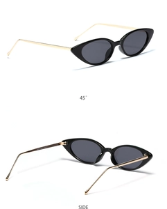 Gros plan de lunettes de soleil œil de chat, monture noire et branches dorées