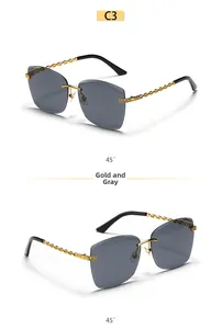 Detailed side view of rimless square sunglasses with golden chain temples and grey lenses