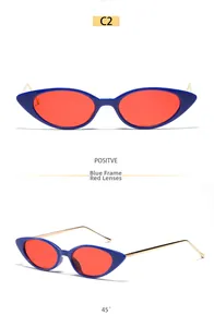 Vue détaillée des lunettes de soleil œil de chat, monture bleue, verres rouges et branches dorées