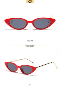 Vue détaillée de lunettes de soleil œil-de-chat rouges avec verres gris et branches dorées