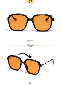 Square black sunglasses with orange tinted lenses and silver rivet detailing