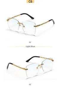 Detail of light blue rimless sunglasses with gold chain temples and 45-degree angle view