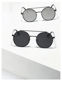 Close-up of retro double-bridge metal sunglasses with grey and silver mirrored lenses
