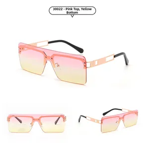 Detail view of oversized rimless sunglasses featuring pink to yellow gradient lenses