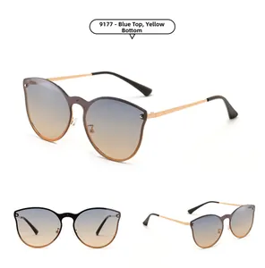 Close-up of blue to yellow gradient rimless cat eye sunglasses with gold metal temples