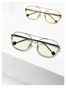 Detailed macro of vintage double-bridge metal glasses frames on white geometric steps