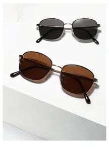 Detail of square metal sunglasses in black and amber brown on geometric display stands
