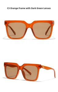 Detailed view of orange frame sunglasses with dark green lenses and golden metal accents