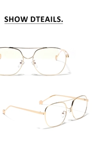 Detail view of large metal pilot glasses with gold double-bridge frame and clear lenses