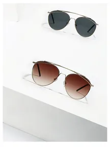 Detailed close-up of double-bridge gold metal aviator sunglasses with gradient lenses