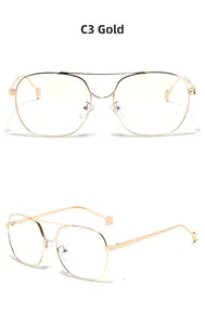 Detail view of large gold metal double bridge frames with thin arms and ball tips