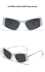 Detail view of white oversized cat-eye sunglasses with gold metal temples and C3 grey lenses