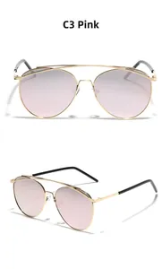 Detail view of pink gradient pilot sunglasses with gold metal double bridge design