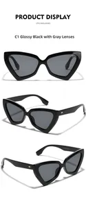 Macro detail of glossy black cat-eye sunglasses with gold metal accents on the temple