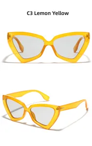 Detail view of oversized cat-eye sunglasses in lemon yellow with grey lenses
