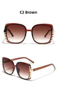 Detail view of large square tea gradient sunglasses with premium gold metal edge trim