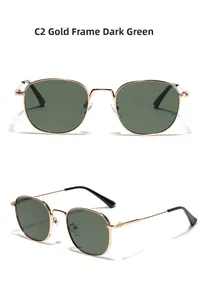 Detail view of gold metal thin frame sunglasses with dark green lenses and black tips