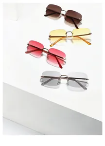 Detail of rimless Y2K sunglasses with colorful lenses and gold metal temples