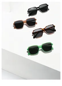 Detail showing four stylish square oversized sunglasses in black, tortoiseshell, and green