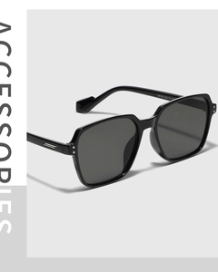 Close-up of square sunglasses with model number 95154 printed on the sleek black temple