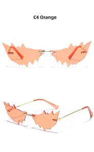 Détail de lunettes de soleil œil-de-chat sans monture orange avec branches dorées