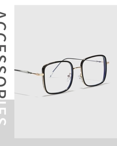Detail view of square black and gold glasses frame with retro metallic temple design