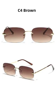 Detail view of C4 brown gradient rimless sunglasses with golden metal bridge and temples