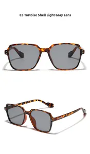 Detail view of square tortoiseshell sunglasses with light grey lenses and rivet accents