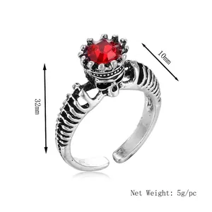 Vintage ghost king ring with silver skeleton design and large red faceted gemstone