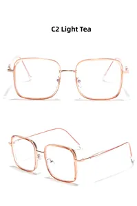 Detail view of square amber frames and light metal temples in a minimalist style