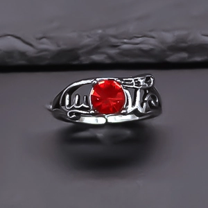Vintage silver alloy ring featuring a faceted red ruby stone and hollow character band