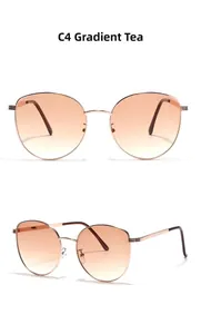 Close-up of cat-eye metal sunglasses with rose gold frame and gradient tea lenses